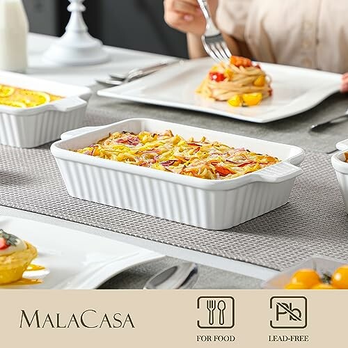 White ceramic bakeware set on dining table with food.