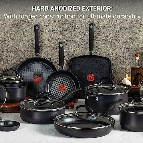 Hard anodized cookware set with various pots and pans.