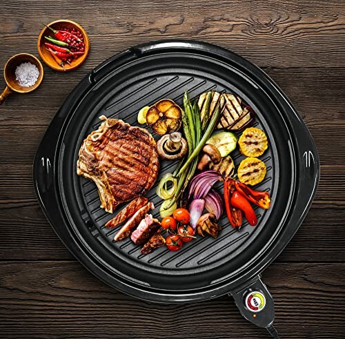 Indoor grill with assorted vegetables and steak.