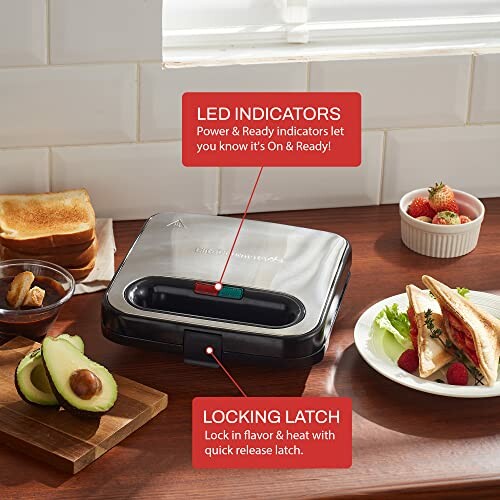 Sandwich maker with LED indicators and locking latch on kitchen counter.