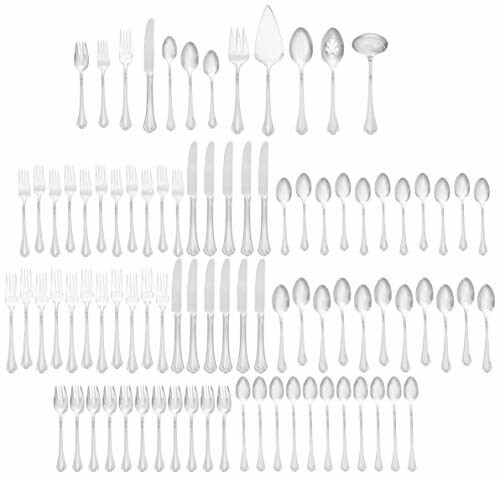 A large set of silver cutlery including forks, knives, and spoons arranged in rows